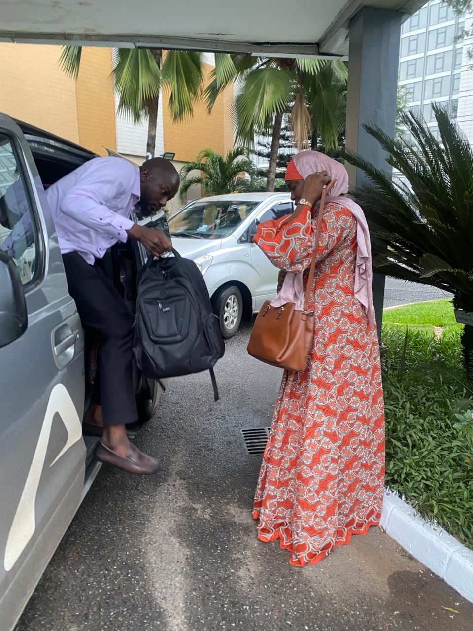 Allons driver helping a guest with luggage at an Accra hotel