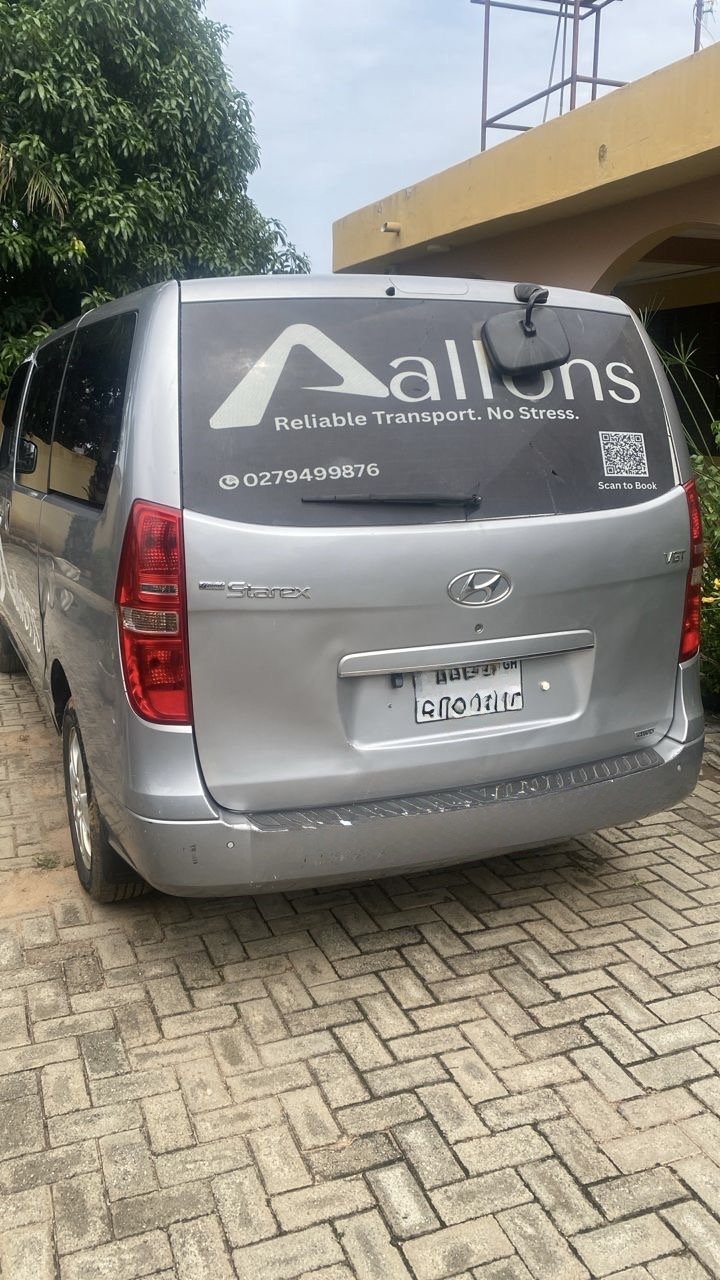 Rear of a branded Allons van reading Reliable Transport. No Stress. with a Scan to Book QR code